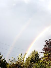 Low angle view of rainbow against sky