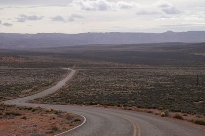 Road passing through landscape against sky