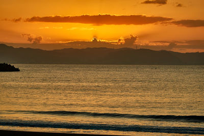 Scenic view of sea against orange sky