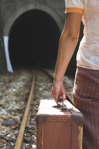 Rear view of woman working on railroad track