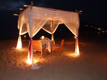 Chairs and tables on beach at night