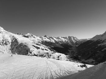 Scenic view of snow covered mountains against sky