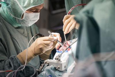 Neurosurgeons opening the cranium during an operation