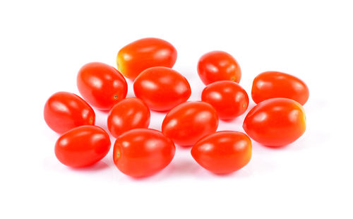 Close-up of tomatoes over white background