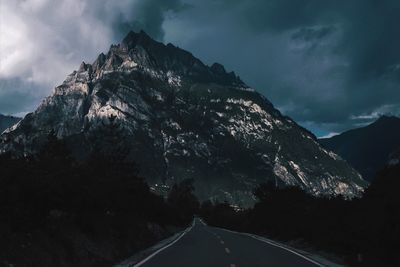 Road amidst mountains against sky