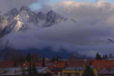 Panoramic view of buildings and mountains against sky