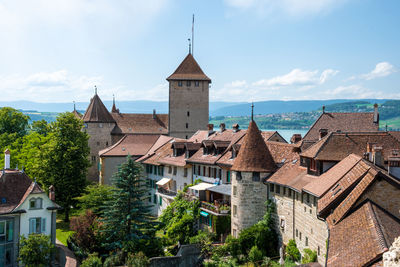 Buildings in town against sky