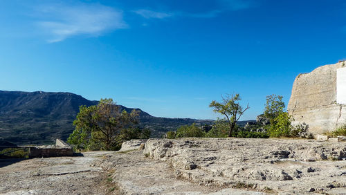 Scenic view of rocky mountains against blue sky