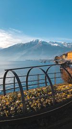 Scenic view of sea by mountains against sky