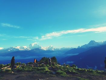 Scenic view of mountains against blue sky on sunny day