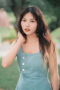 Portrait of young woman standing outdoors