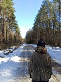 Rear view of man on snow covered land