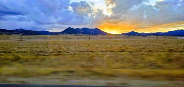 Scenic view of field against sky during sunset