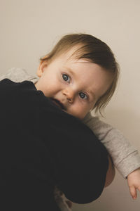 Cute girl looking away against wall