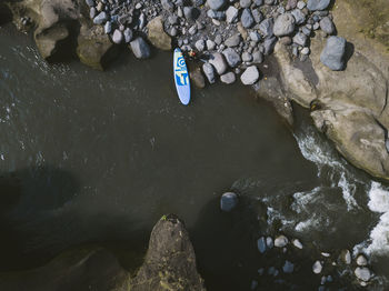 Surfer with sup surfboard at river