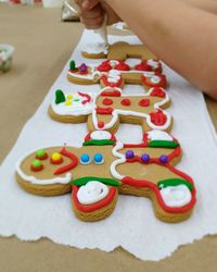 Close-up of child decorating gingerbread