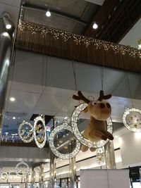 Low angle view of illuminated chandelier hanging on ceiling