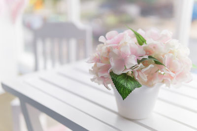 Close-up of white roses in vase on table