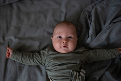 Portrait of cute baby boy sleeping on bed at home
