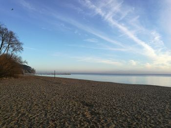 Scenic view of beach against blue sky