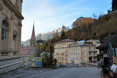 Street amidst buildings in city against sky