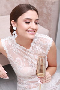 Portrait of smiling woman drinking glass