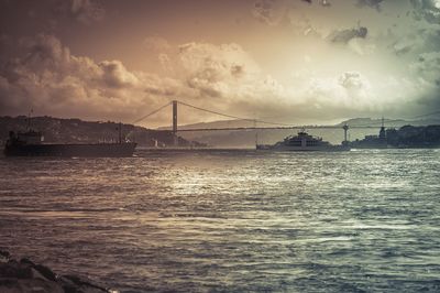 Bridge over sea at sunset