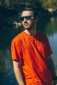 Young man wearing sunglasses standing outdoors