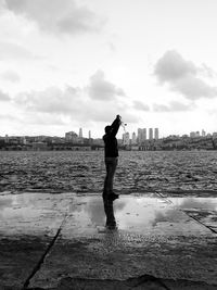 Full length side view of man standing in city