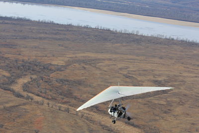 High angle view of airplane flying over land