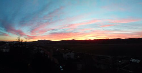 Scenic view of mountains against sky at sunset