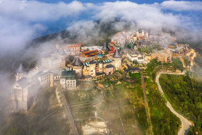 High angle view of buildings and trees against sky