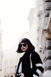 Young woman wearing sunglasses standing outdoors