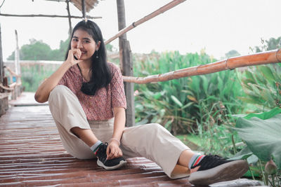 Portrait of smiling woman sitting outdoors