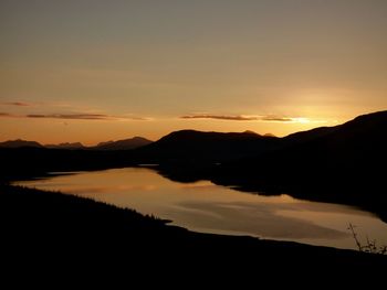 Scenic view of silhouette mountains against sky at sunset