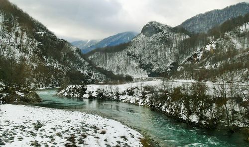 Scenic view of river through mountains