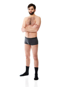 Portrait of young man standing against white background