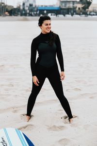 Full length of young woman at beach