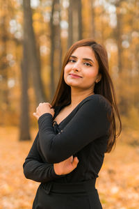 Portrait of young woman standing outdoors