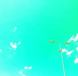 Low angle view of street light against blue sky