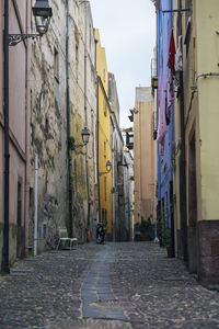 Low angle view of narrow alley along buildings