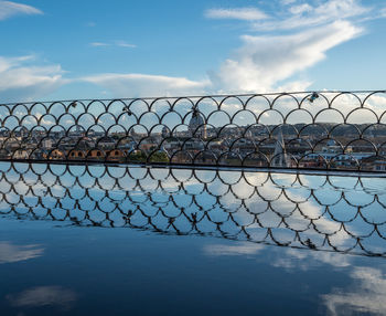 Scenic view of sea seen through chainlink fence