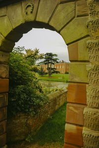 Built structure by wall against sky