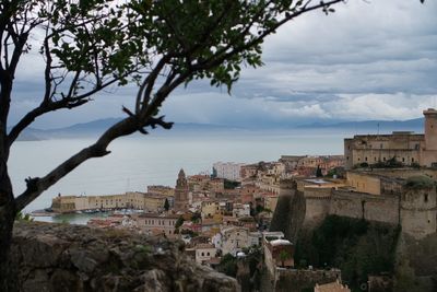 Townscape by sea against sky