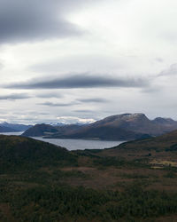 Scenic view of mountains against cloudy sky