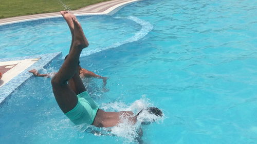 High angle view of man diving into swimming pool