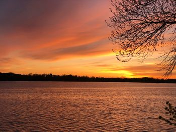 Scenic view of lake against romantic sky at sunset