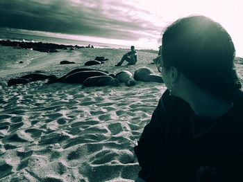 Close-up of woman by sea against sky