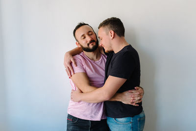 Two gay man hugging each other.