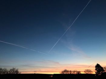 Low angle view of vapor trails in sky